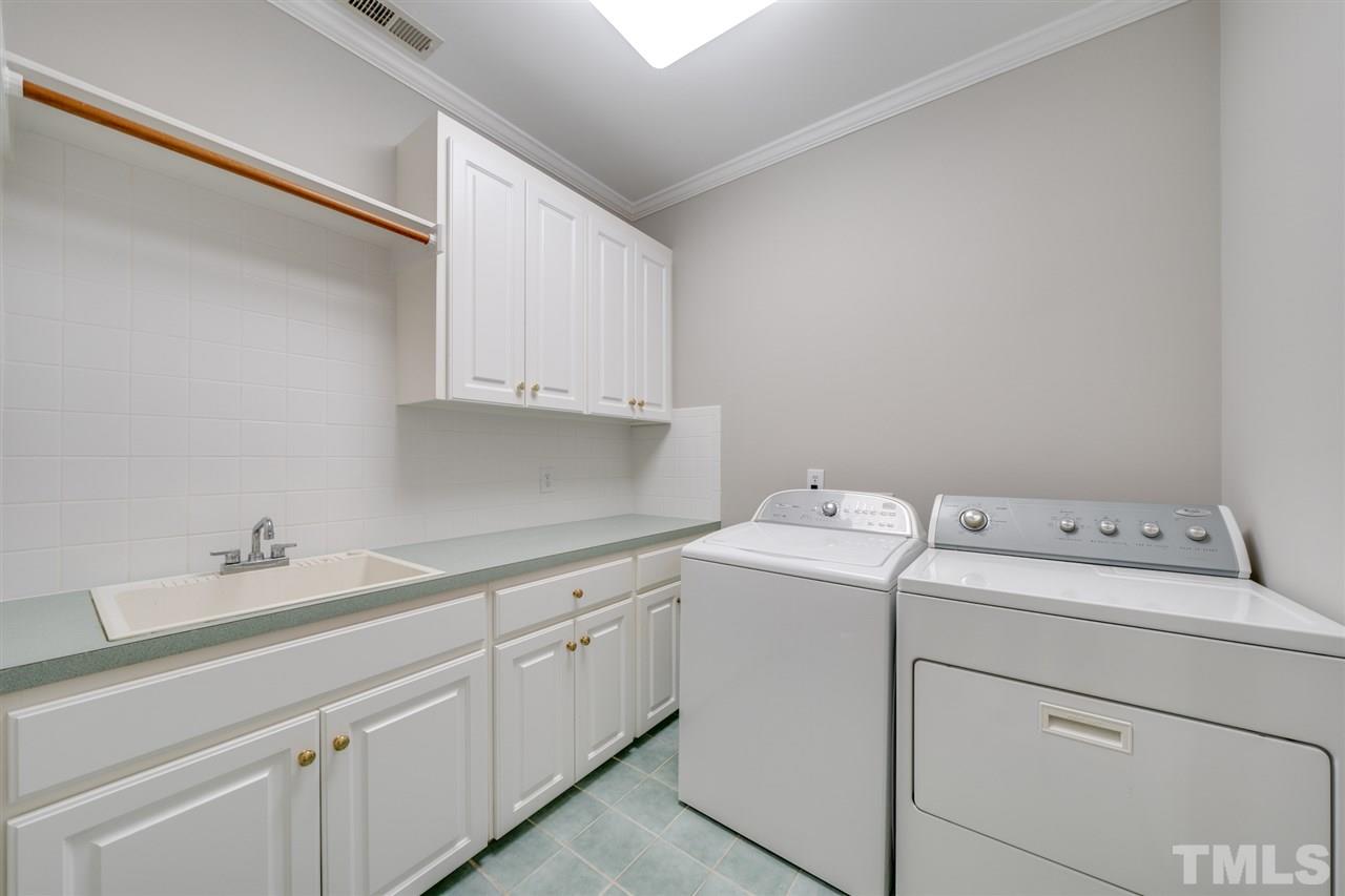 209 Claflin Court Raleigh, NC 27614 - Photo 18 of 30 2nd floor utility room lots of cabinets for storage.