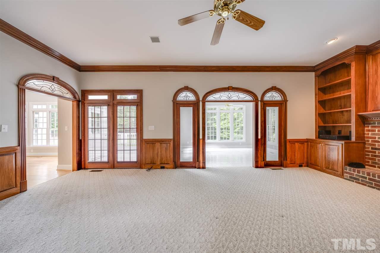 209 Claflin Court Raleigh, NC 27614 - Photo 4 of 30 Wide open family room with lots of natural sunlight. Display your family photos, or your favorite keepsakes, on these custom built in shelves.