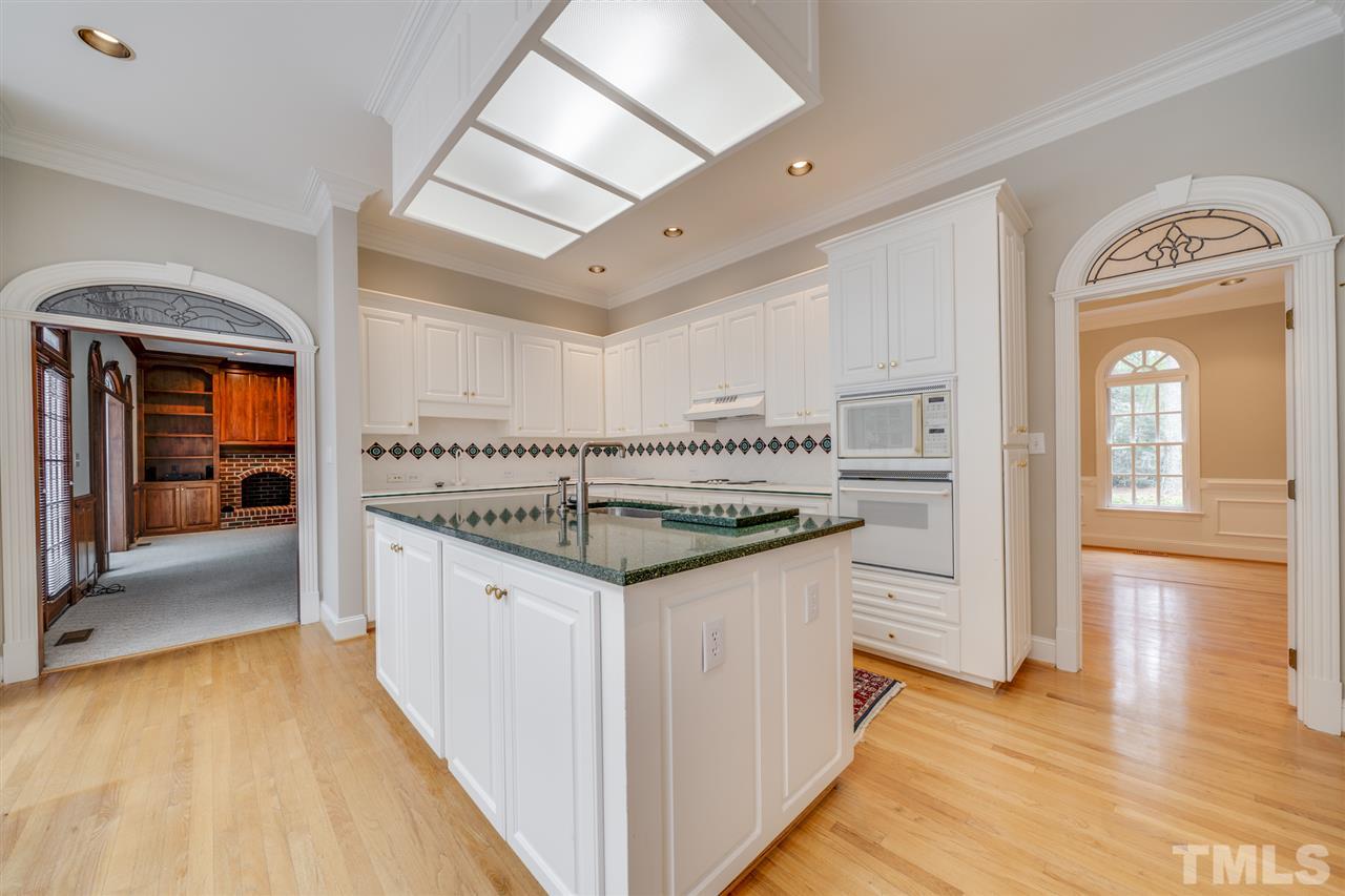 209 Claflin Court Raleigh, NC 27614 - Photo 8 of 30 Solid surface counter tops, beautiful hardwood floors and lots of cabinets for storage!