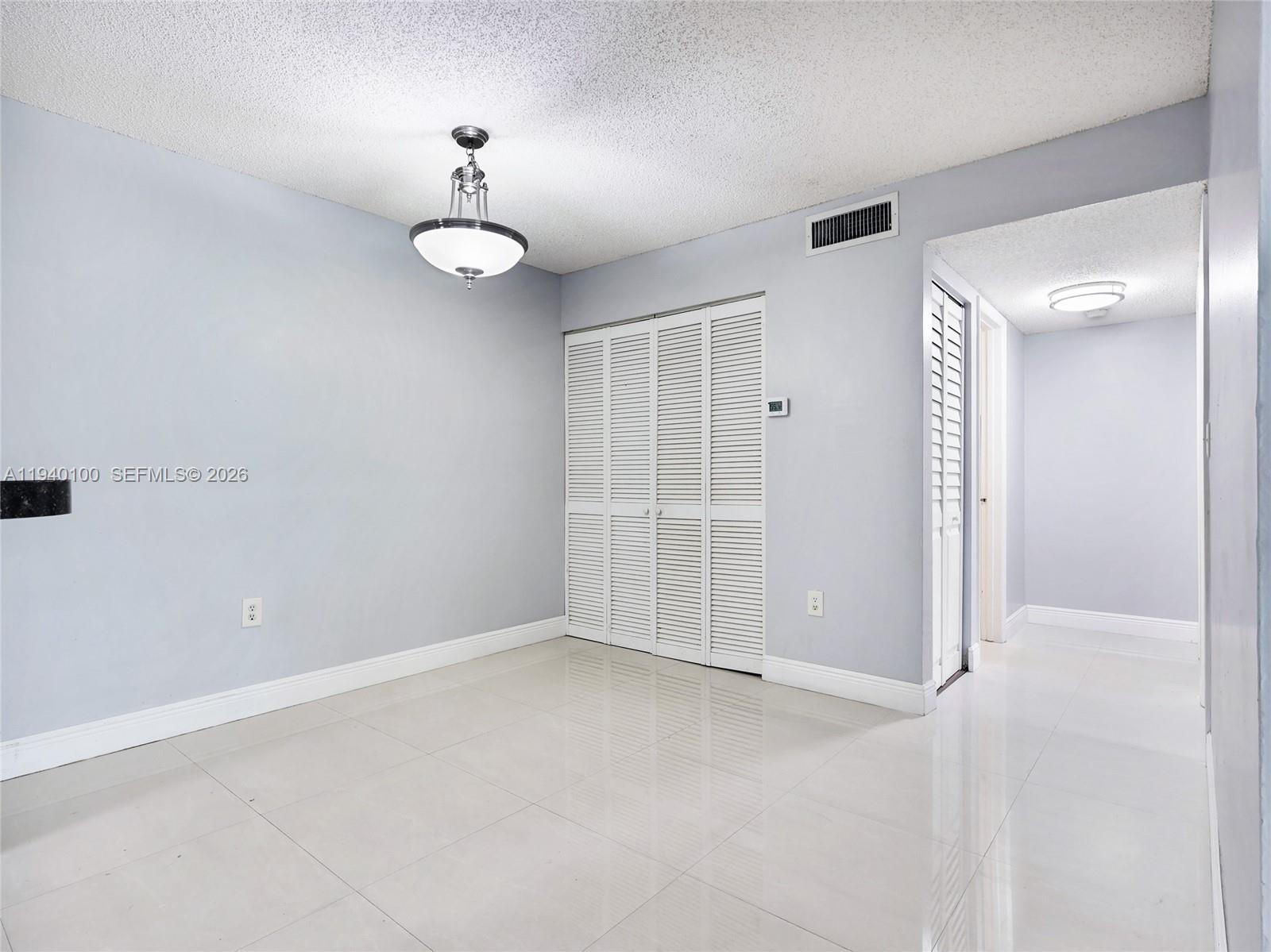 15520 Southwest 80th Street, Unit B301 Miami, FL 33193 - Photo 11 of 26 an empty room with closet and windows