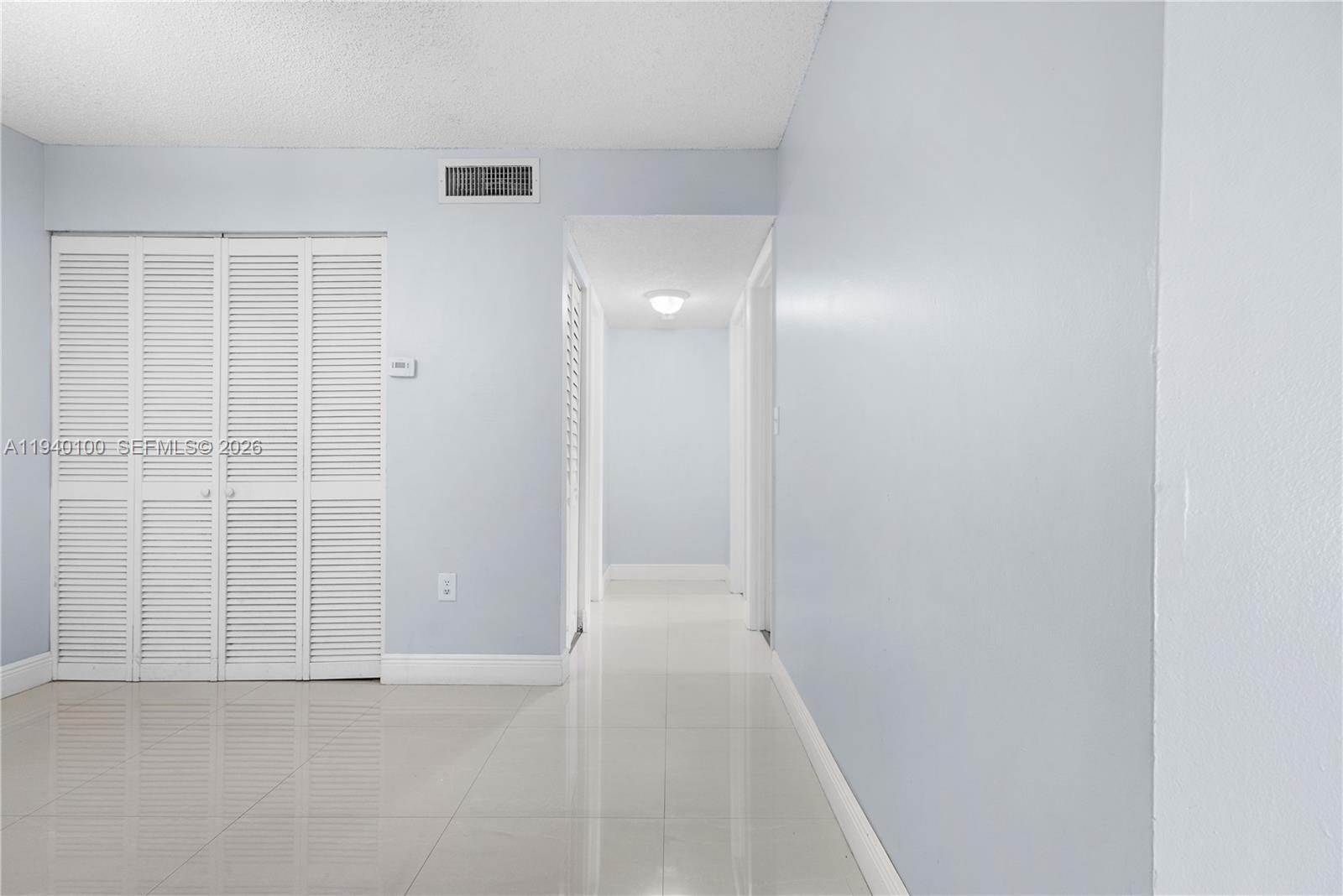 15520 Southwest 80th Street, Unit B301 Miami, FL 33193 - Photo 12 of 26 an empty room with windows