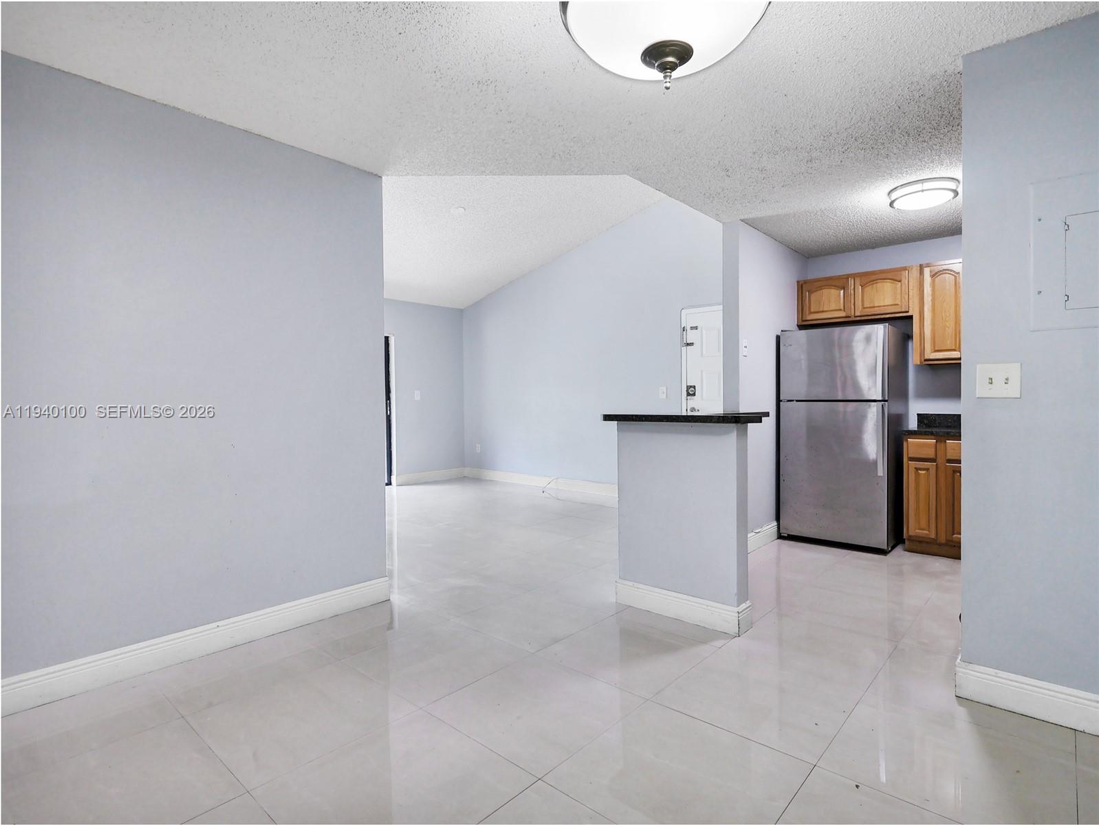 15520 Southwest 80th Street, Unit B301 Miami, FL 33193 - Photo 13 of 26 a view of a kitchen with a refrigerator a microwave and a sink