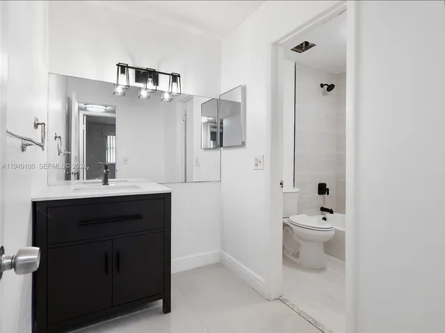 a bathroom with a toilet sink shower and mirror