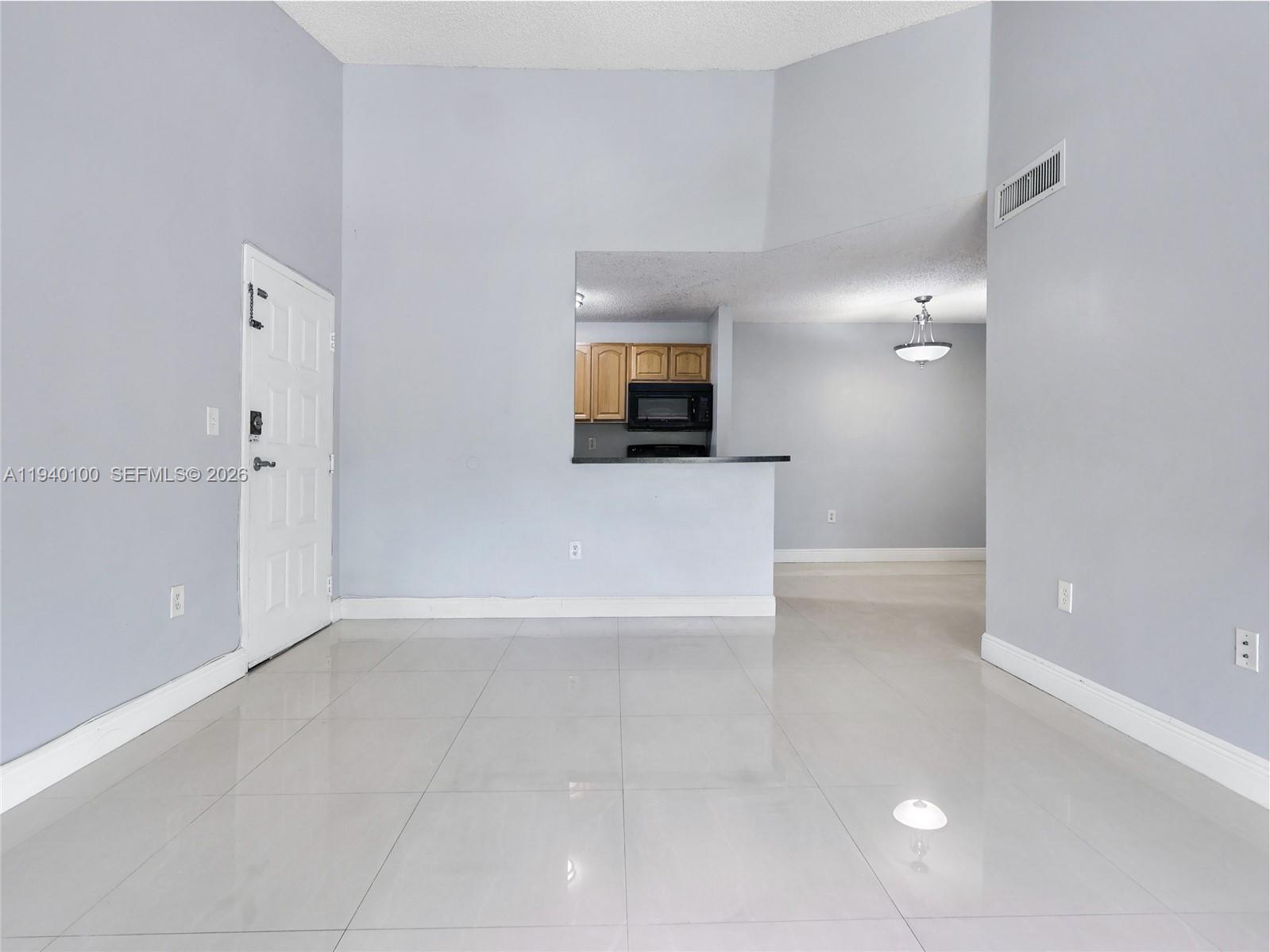 15520 Southwest 80th Street, Unit B301 Miami, FL 33193 - Photo 9 of 26 a view of a hallway to a room with a bathroom