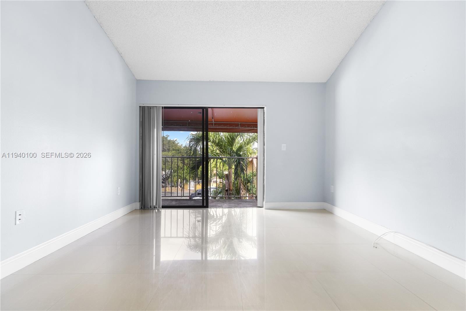 15520 Southwest 80th Street, Unit B301 Miami, FL 33193 - Photo 10 of 26 a view of an empty room with a window