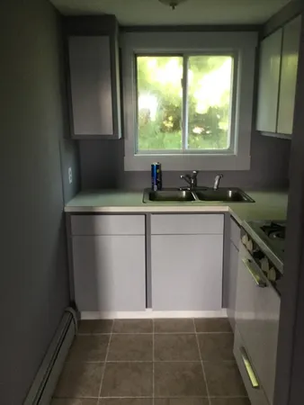 a kitchen with a sink stove and cabinets