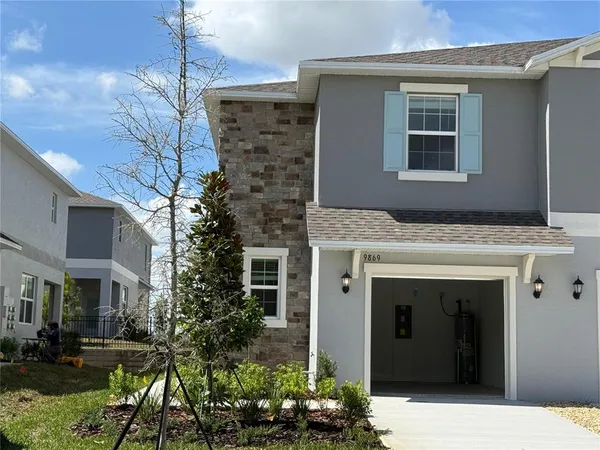 a front view of a house with plants
