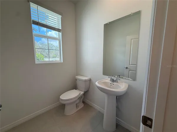 a kitchen with a refrigerator a microwave a sink and cabinets