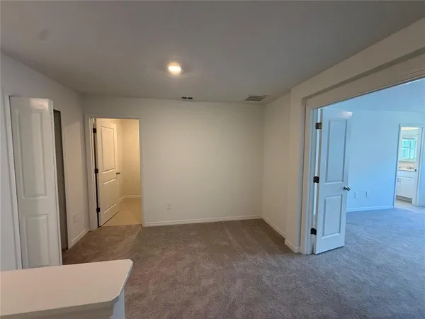 a view of a house with a yard and potted plants