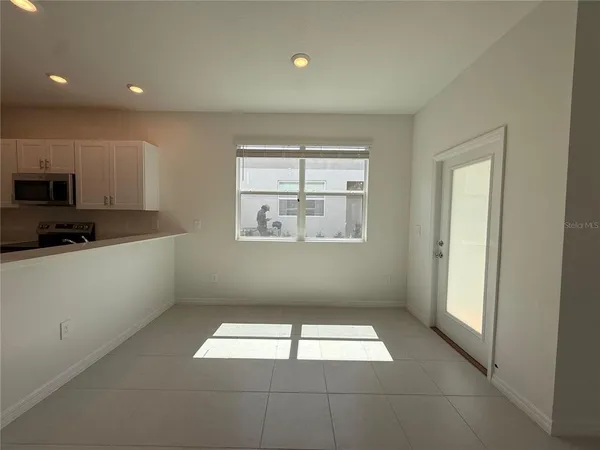 a view of kitchen with kitchen island and stainless steel appliances