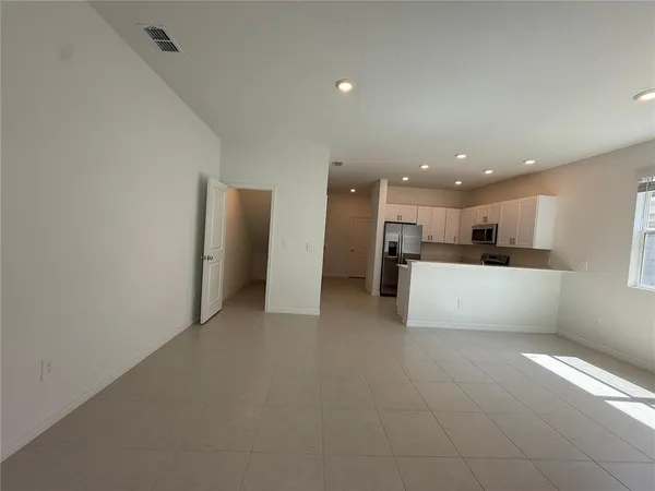 a view of a kitchen with a sink and a refrigerator