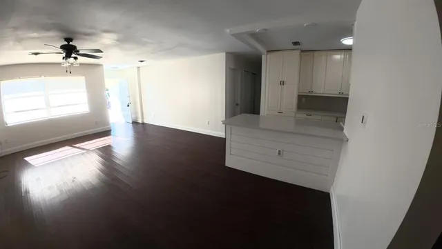 an empty room with windows and entrance