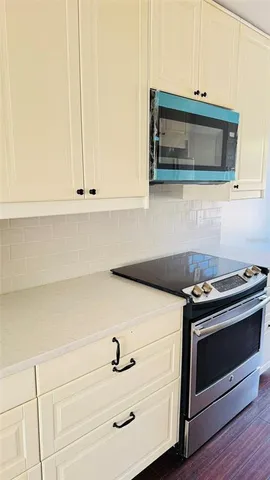 a kitchen with a stove and a microwave