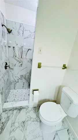 a white toilet sitting next to a bathroom sink