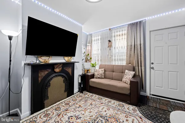 a living room with a flat screen tv and a fireplace