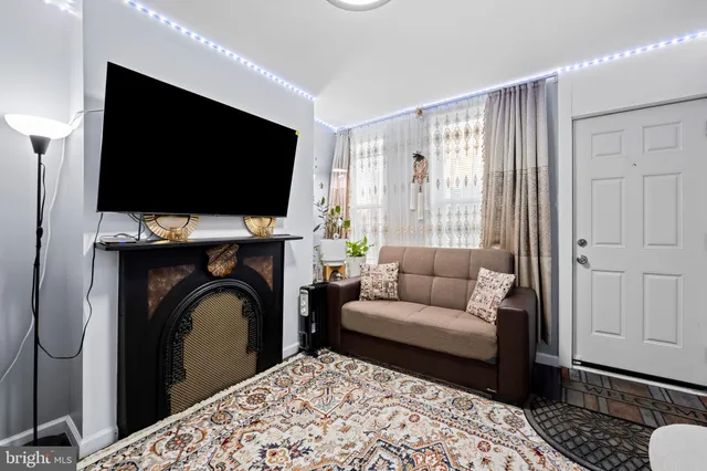 a living room with a flat screen tv and a fireplace