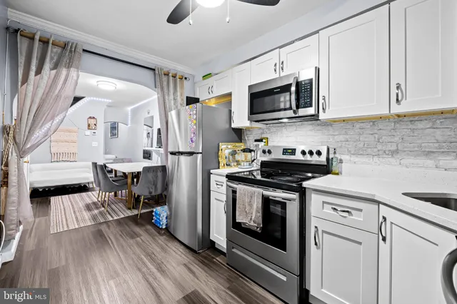 a kitchen with stainless steel appliances a stove microwave and refrigerator