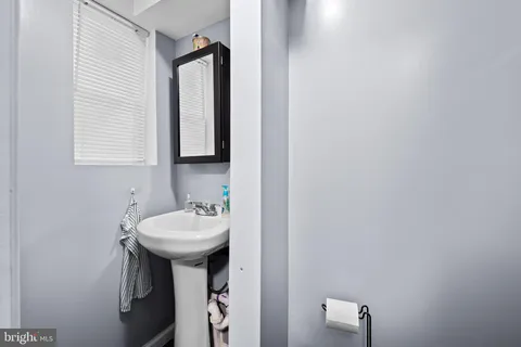 a bathroom with a sink a mirror and a window