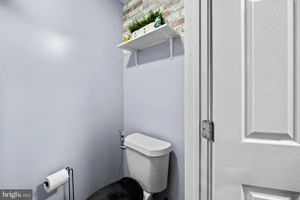 a white toilet sitting next to a shower