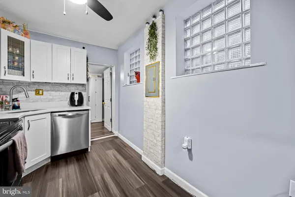 a kitchen with a refrigerator and white cabinets