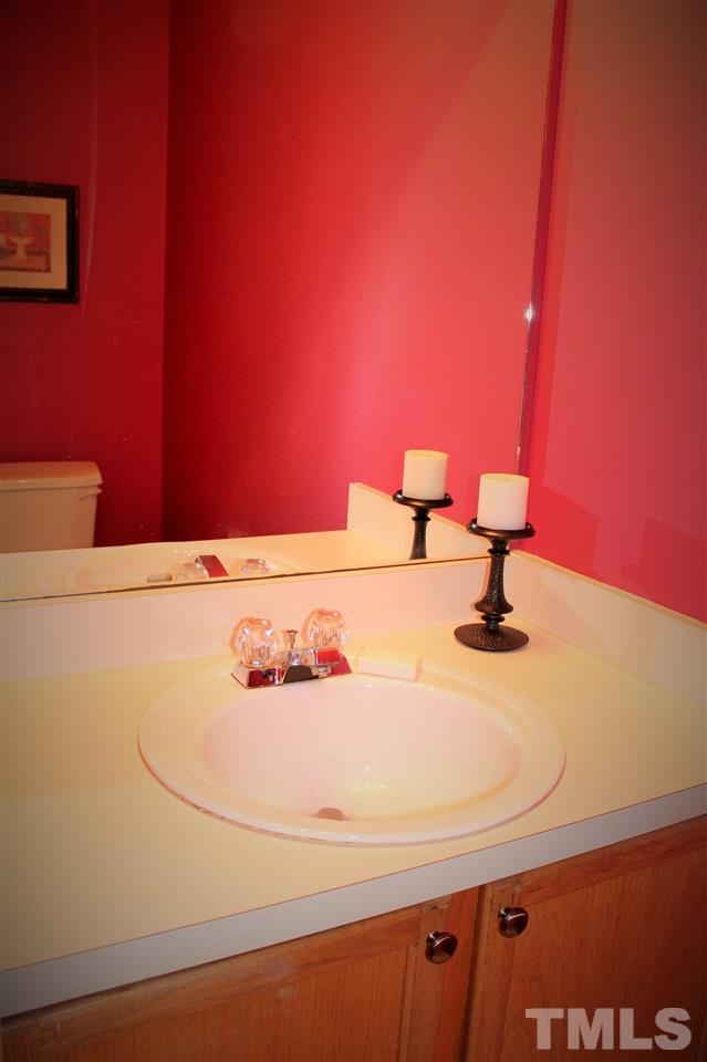 5022 Gable Ridge Drive Durham, NC 27713 - Photo 11 of 24 a bathroom with a sink and a mirror