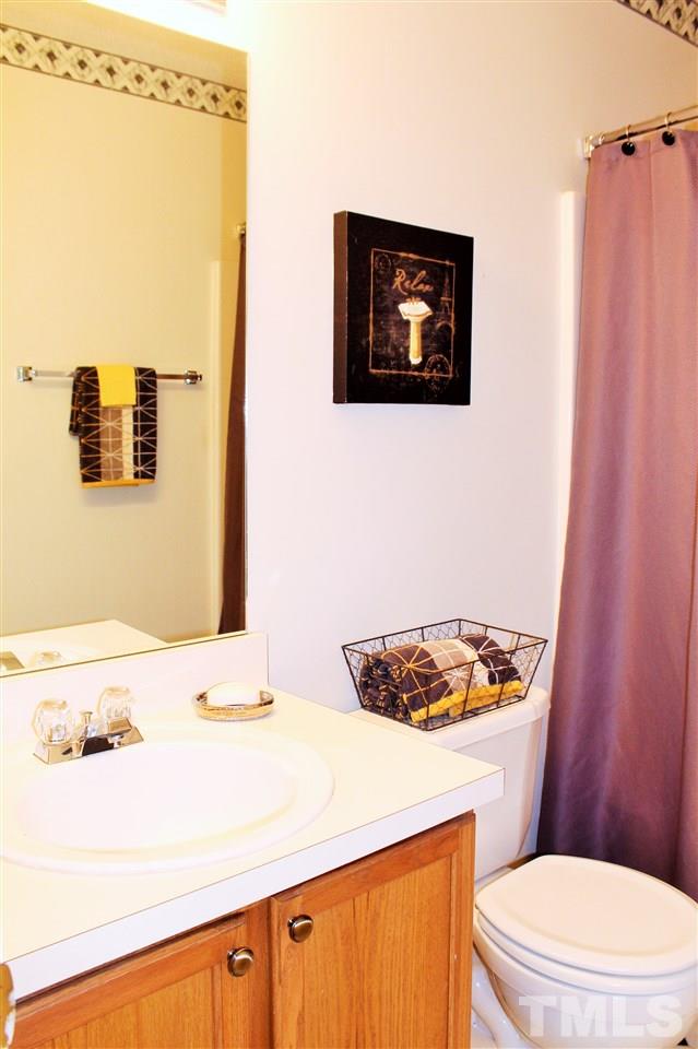 5022 Gable Ridge Drive Durham, NC 27713 - Photo 14 of 24 a bathroom with a sink a toilet and shower