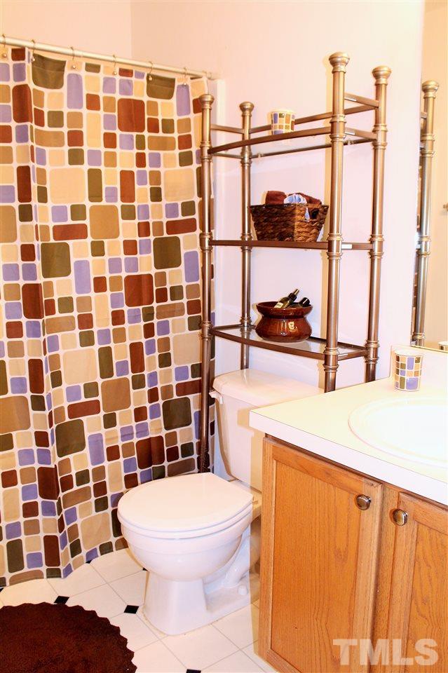 5022 Gable Ridge Drive Durham, NC 27713 - Photo 18 of 24 a bathroom with a sink toilet and shower