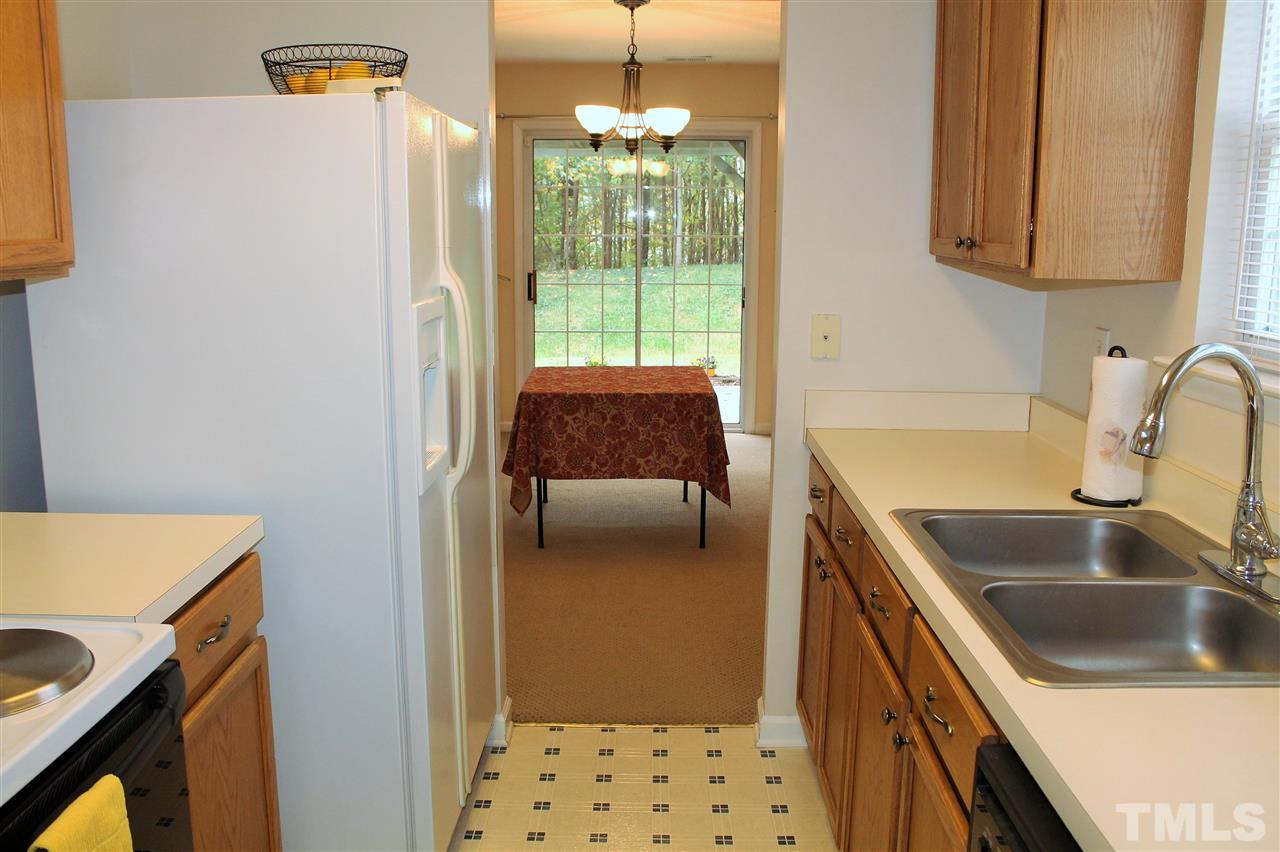 5022 Gable Ridge Drive Durham, NC 27713 - Photo 8 of 24 a kitchen with a sink and a refrigerator