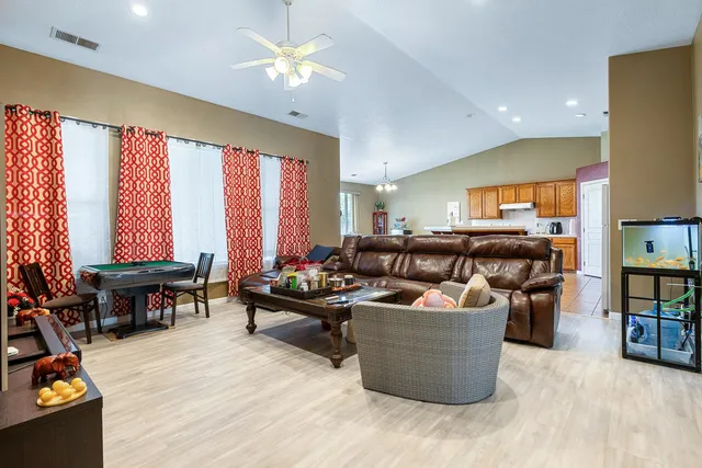 a living room with furniture and a wooden floor
