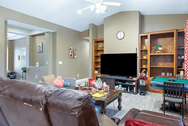 a kitchen with stainless steel appliances a sink a stove a refrigerator cabinets and dining table