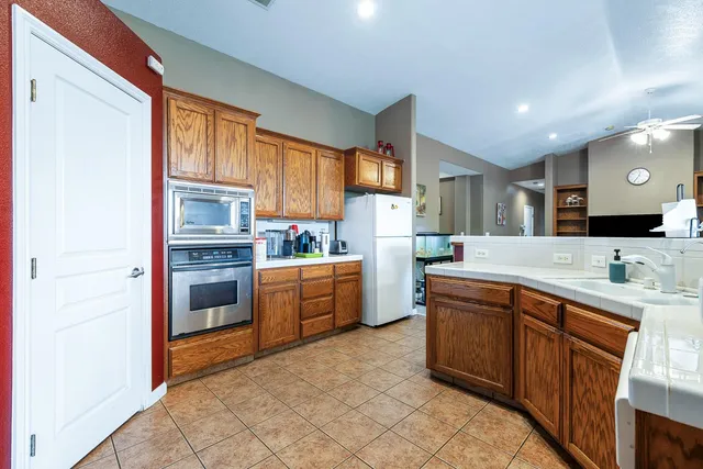 a kitchen with kitchen island granite countertop a sink window and cabinets