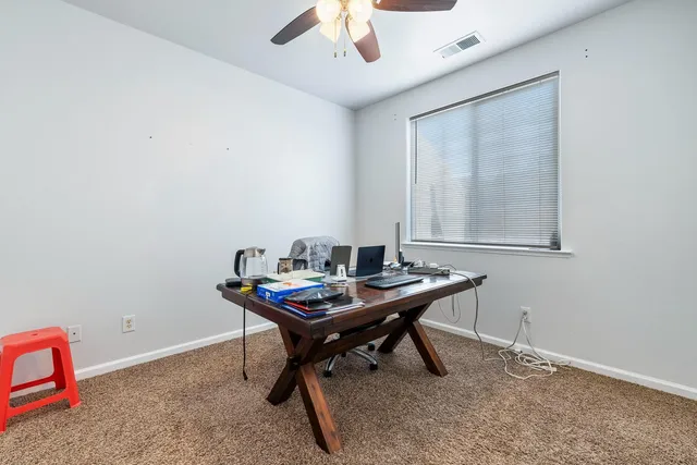 a view of a workspace with furniture