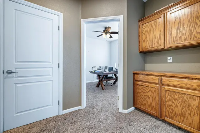 a view of washer and dryer with kitchen in the background