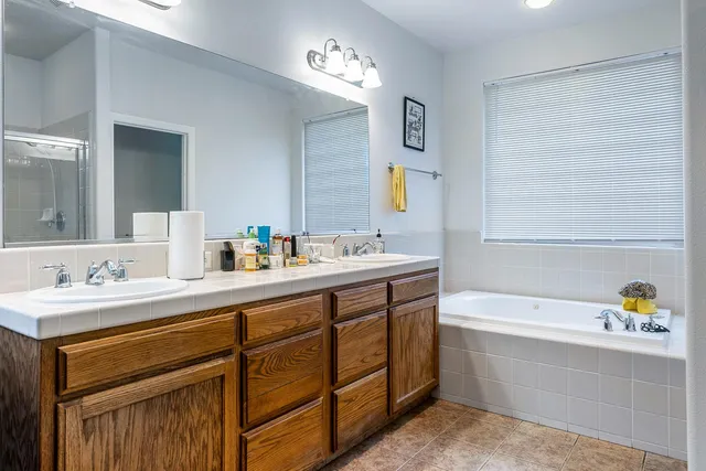 a living room with furniture a mirror and a dresser