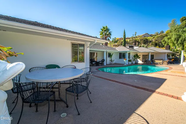 a view of a dining room with furniture a chandelier and wooden floor