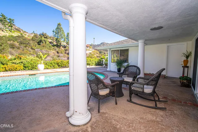 a view of a hallway with dining room and wooden floor