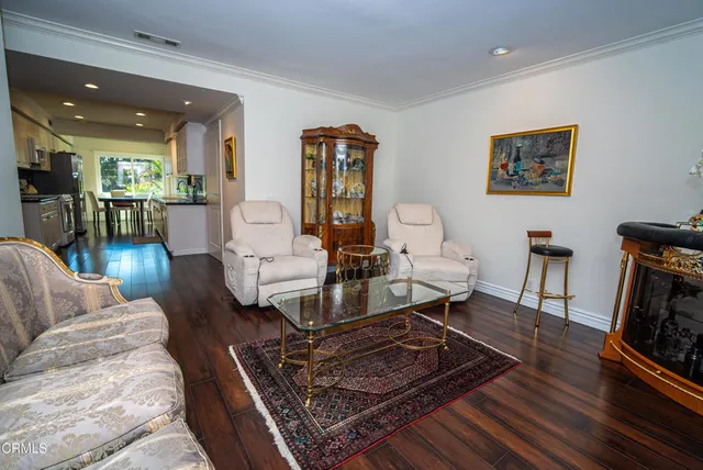 an aerial view of a house with swimming pool and outdoor seating