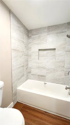 a bathroom with a bathtub and a toilet