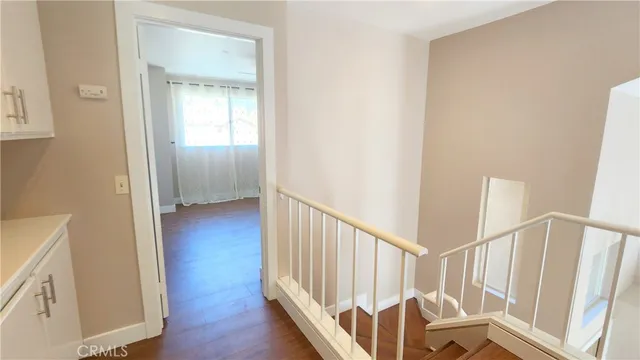 a view of a hallway with wooden floor and entryway