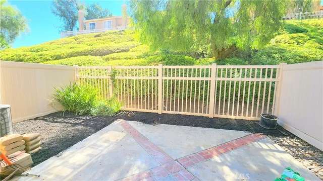 a view of a garden with a wooden fence
