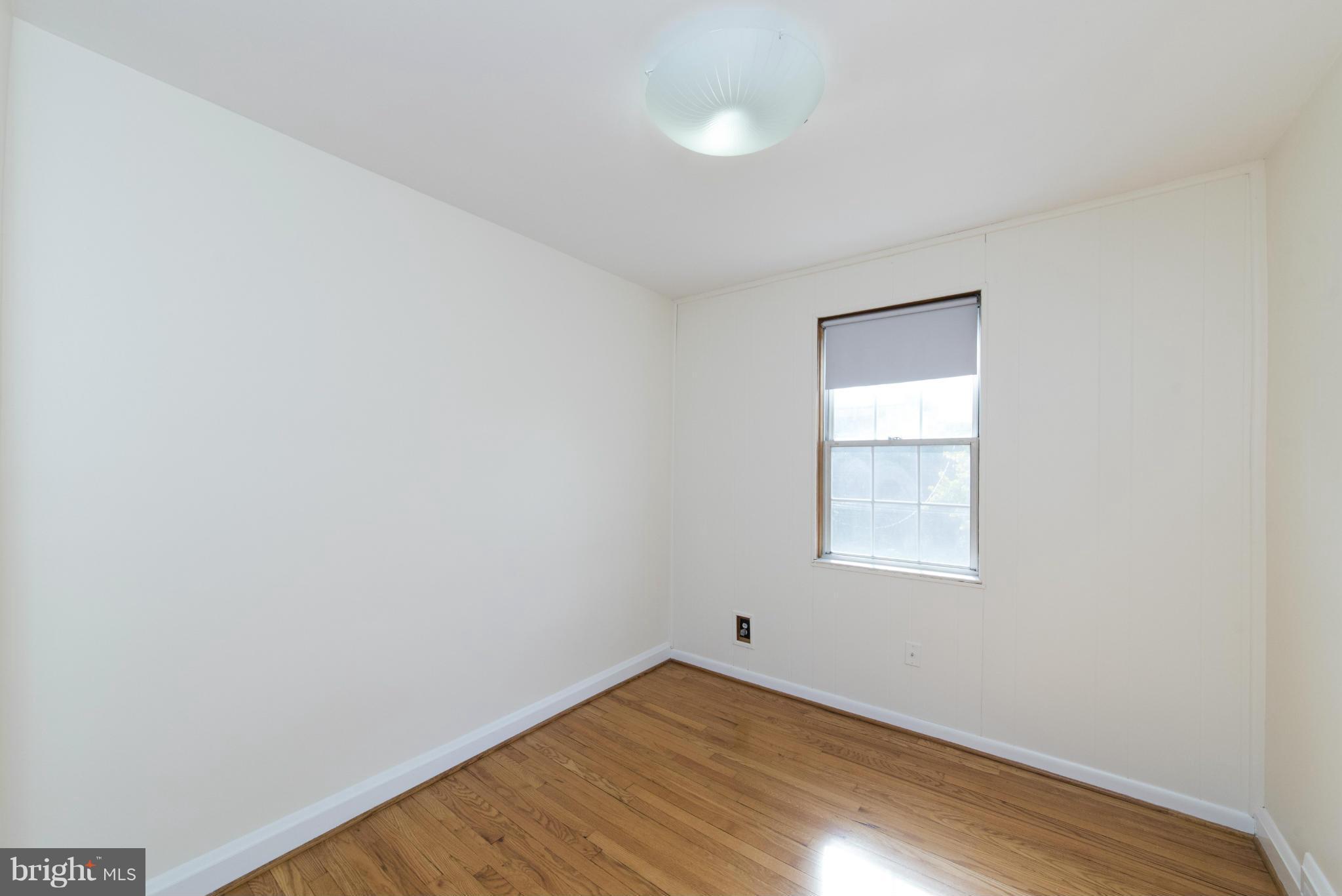 1964 Edgewood Road Baltimore, MD 21286 - Photo 22 of 30 an empty room with wooden floor and windows