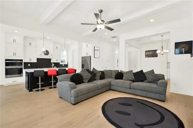 a living room with furniture and a chandelier