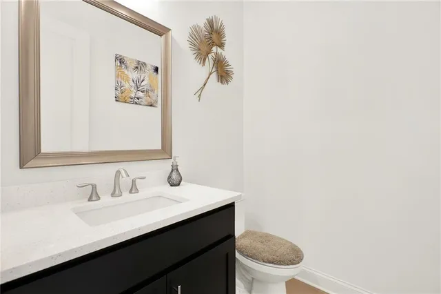 a bathroom with a sink a toilet and mirror