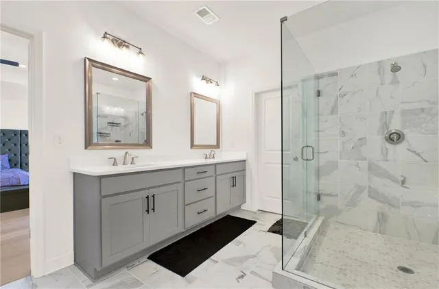 a spacious bathroom with double sink and a mirror
