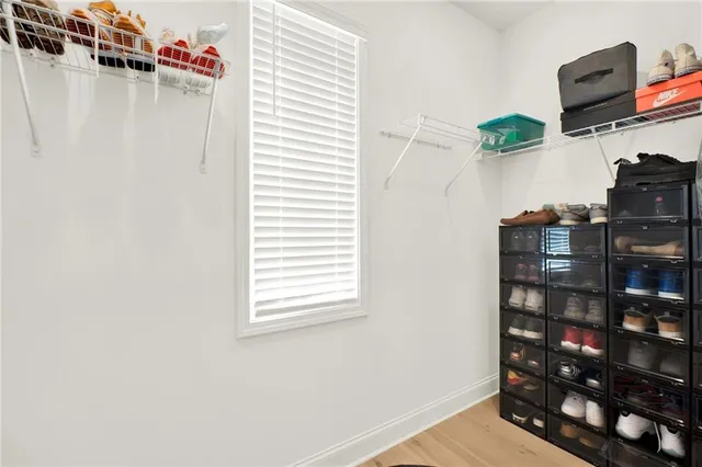 a spacious bathroom with a double vanity sink a mirror and a bathtub