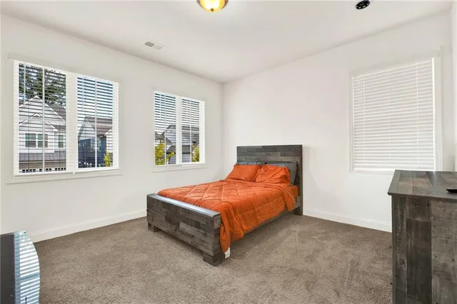 a bathroom with a double vanity sink a mirror and a bathtub