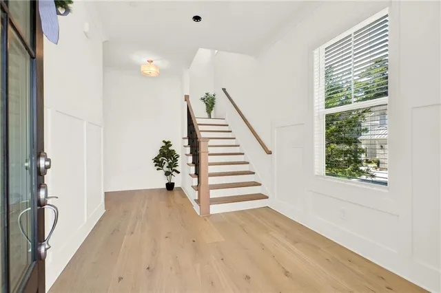 a view of a hallway with stairs and a window