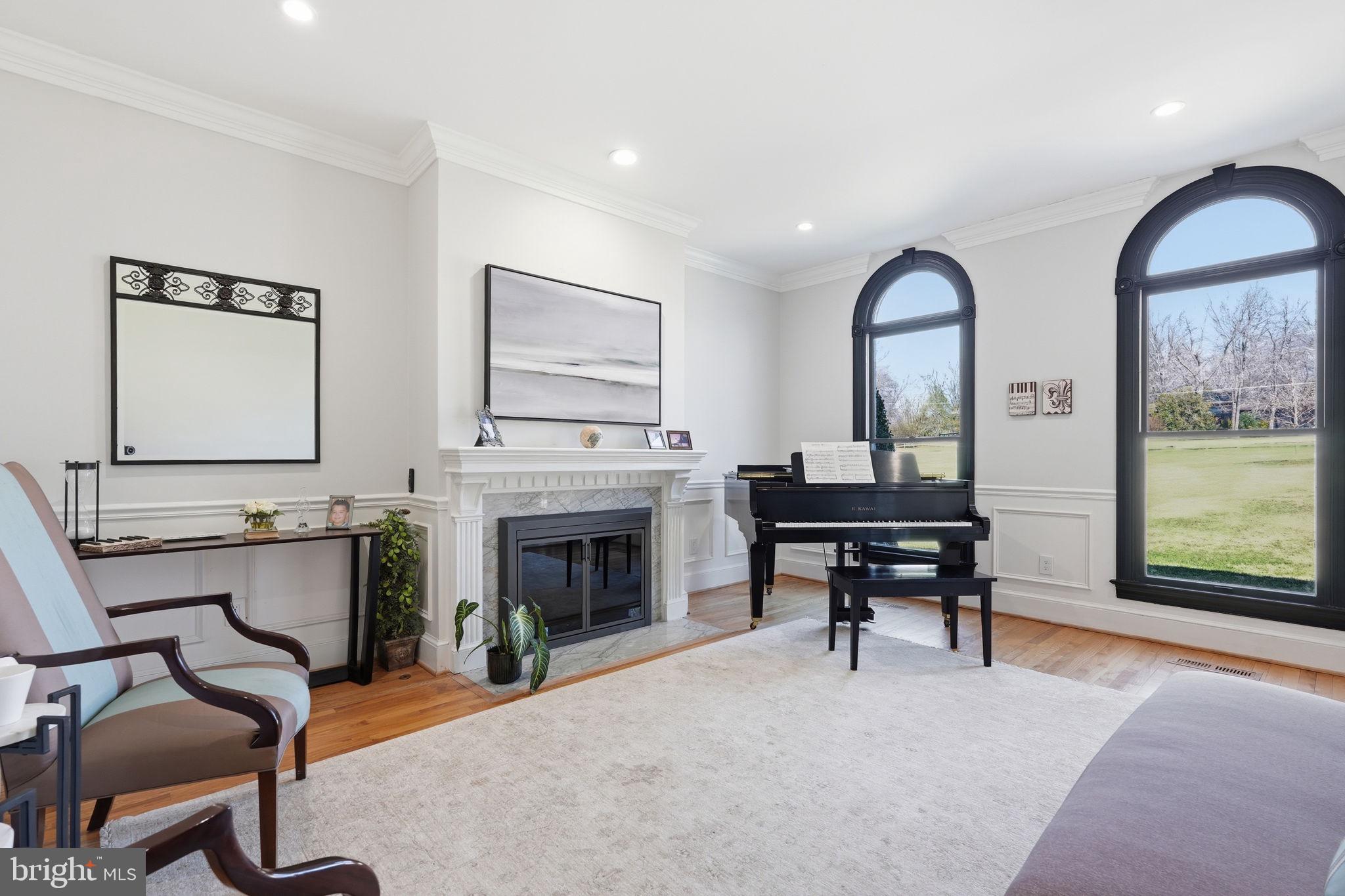 310 Springvale Road Great Falls, VA 22066 - Photo 16 of 59 a living room with furniture a fireplace and a large window