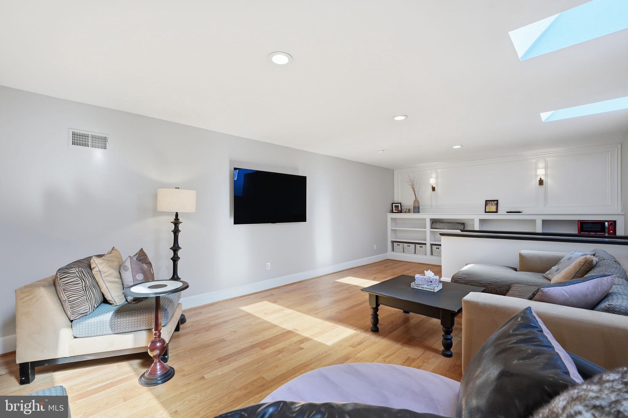 310 Springvale Road Great Falls, VA 22066 - Photo 33 of 59 a living room with furniture and a flat screen tv