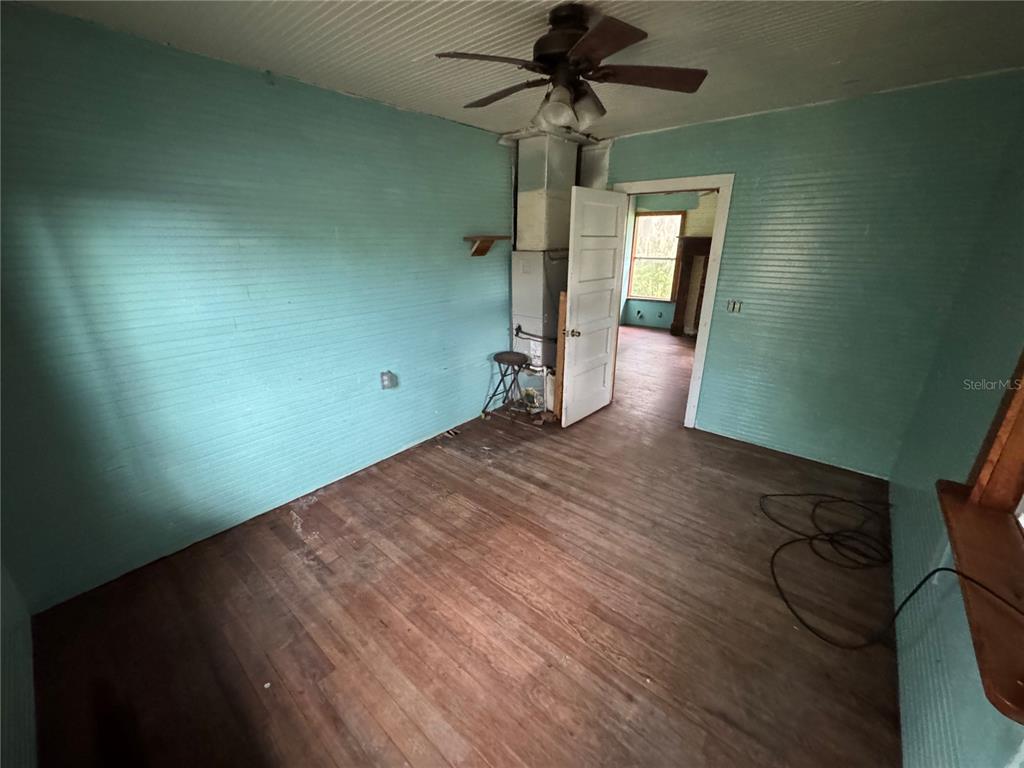 850 Menton Road Pierson, FL 32180 - Photo 11 of 35 a view of empty room with wooden floor and fan